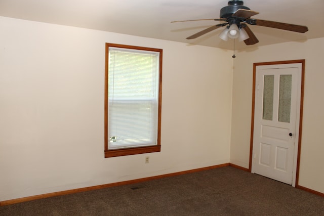 carpeted spare room featuring ceiling fan