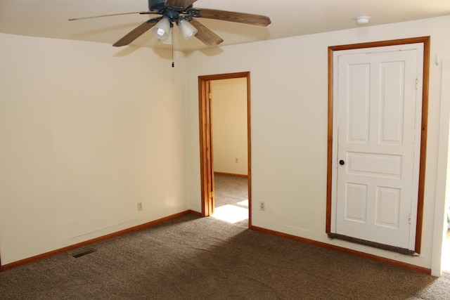 carpeted spare room with ceiling fan