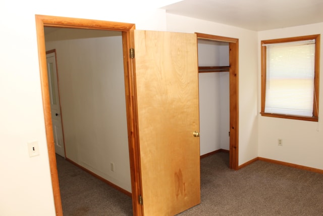 unfurnished bedroom featuring a closet and carpet