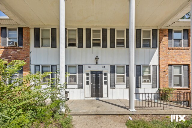 entrance to property featuring cooling unit