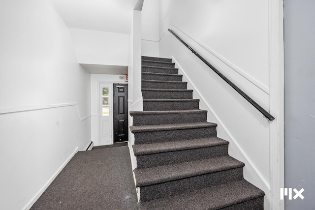 stairway featuring carpet and a baseboard radiator