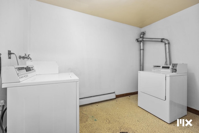 clothes washing area featuring independent washer and dryer and a baseboard heating unit