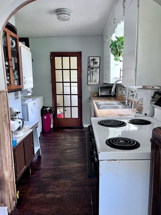 kitchen featuring washer and clothes dryer, dark wood-type flooring, sink, white cabinets, and white range with electric cooktop