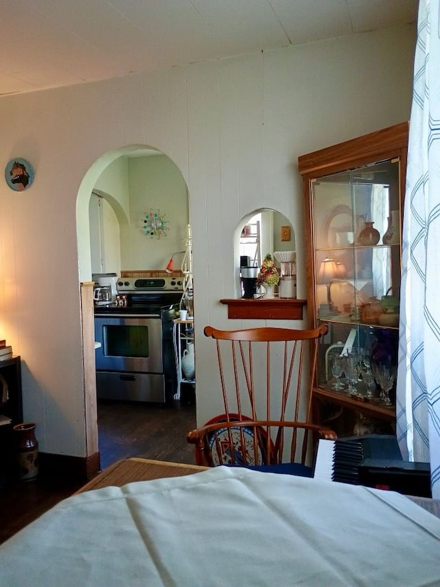 1460 S Dye Rd, Flint, MI 48532 - bedroom featuring arched walkways and dark wood-style flooring