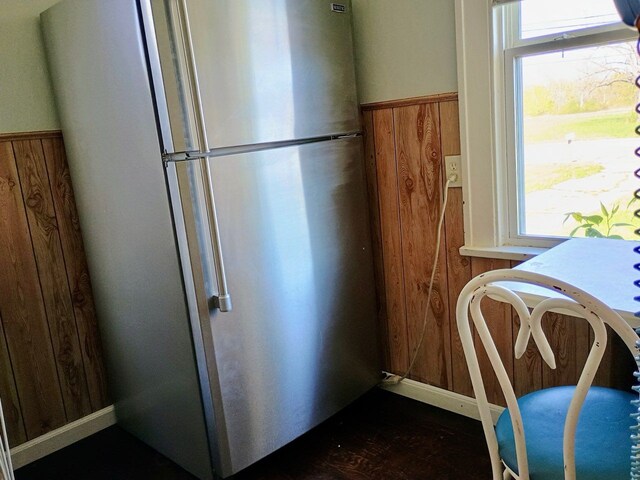 1460 S Dye Rd, Flint, MI 48532 - kitchen with freestanding refrigerator, wooden walls, and wainscoting