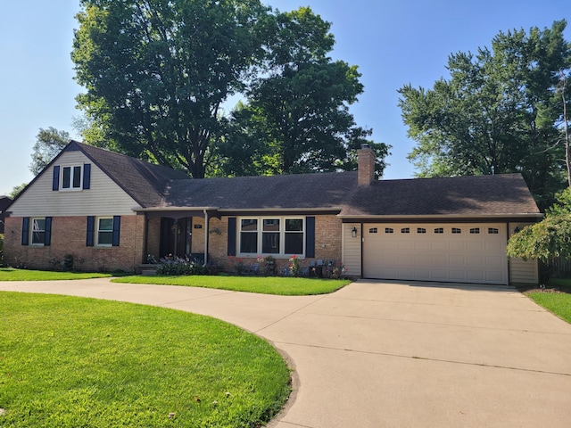 77 Maple Ln, Coldwater, MI 49036 - view of front of home featuring driveway, a front yard, an attached garage, a chimney, and brick siding