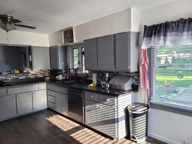 77 Maple Ln, Coldwater, MI 49036 - kitchen with gray cabinets, dishwasher, dark countertops, dark wood-type flooring, and backsplash