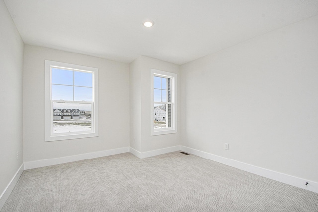 empty room featuring light colored carpet