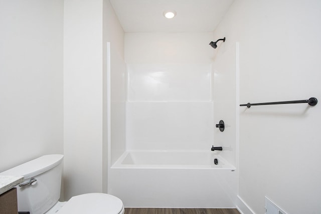 bathroom with wood-type flooring, toilet, and shower / bath combination