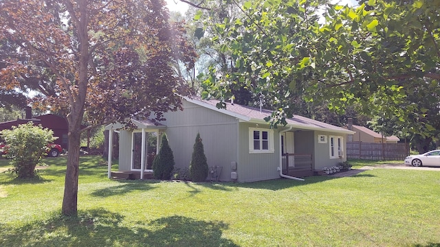 view of property exterior with a yard