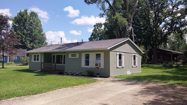 single story home with cooling unit, a front lawn, and covered porch