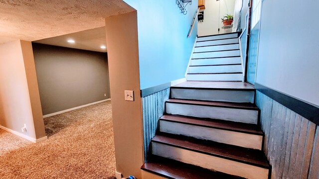 12448 Jefferson Rd, Morley, MI 49336 - stairway featuring carpet flooring, a textured ceiling, baseboards, and recessed lighting