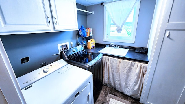 clothes washing area with washer and clothes dryer, sink, and cabinets