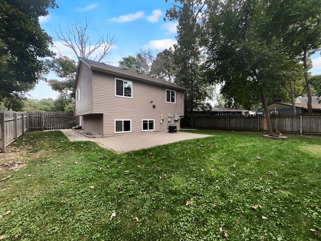 back of house with a yard, a patio area, and central air condition unit