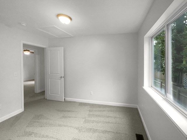 carpeted empty room featuring ceiling fan