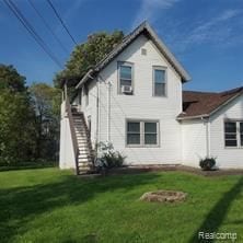 rear view of property with a yard