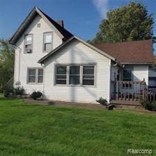4414 S Martin Luther King Jr Blvd, Lansing, MI 48910 - back of property featuring a lawn and a chimney