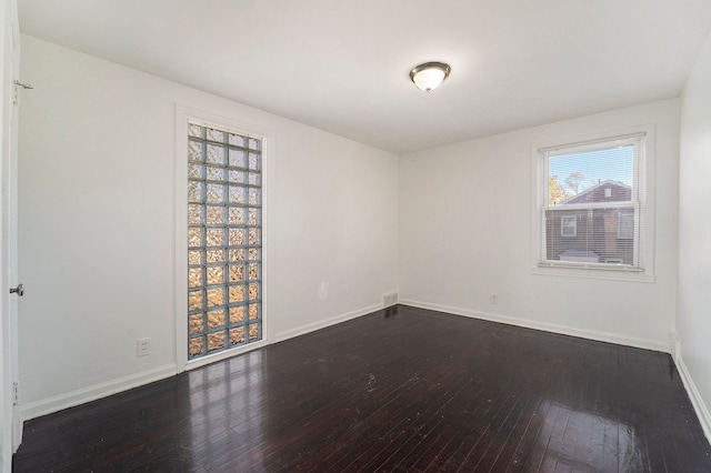 spare room featuring dark hardwood / wood-style flooring