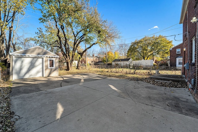 view of patio / terrace featuring a garage and an outbuilding