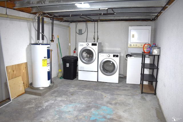 basement featuring washing machine and dryer and water heater