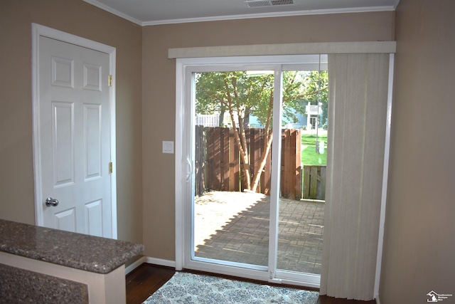 doorway featuring dark hardwood / wood-style floors and crown molding