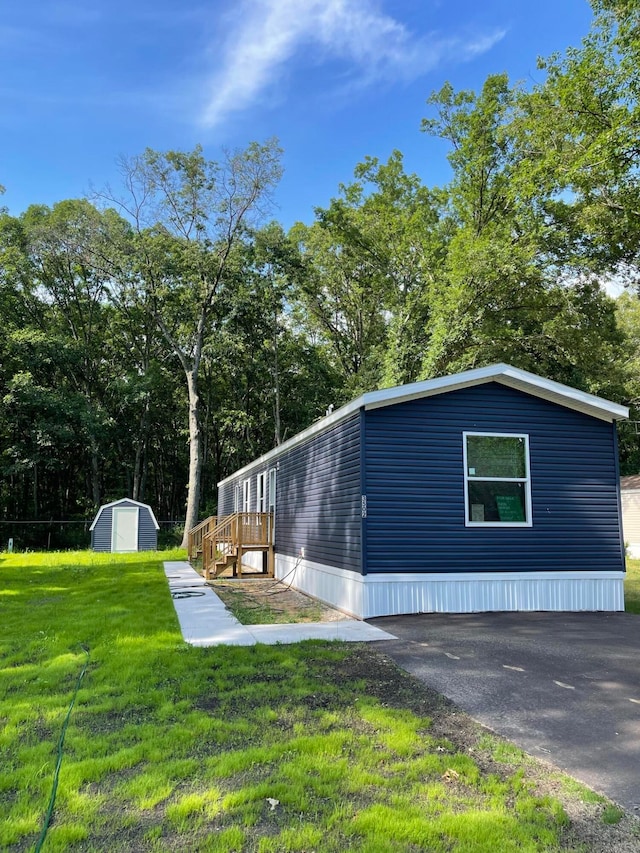 view of property exterior with a shed and a lawn