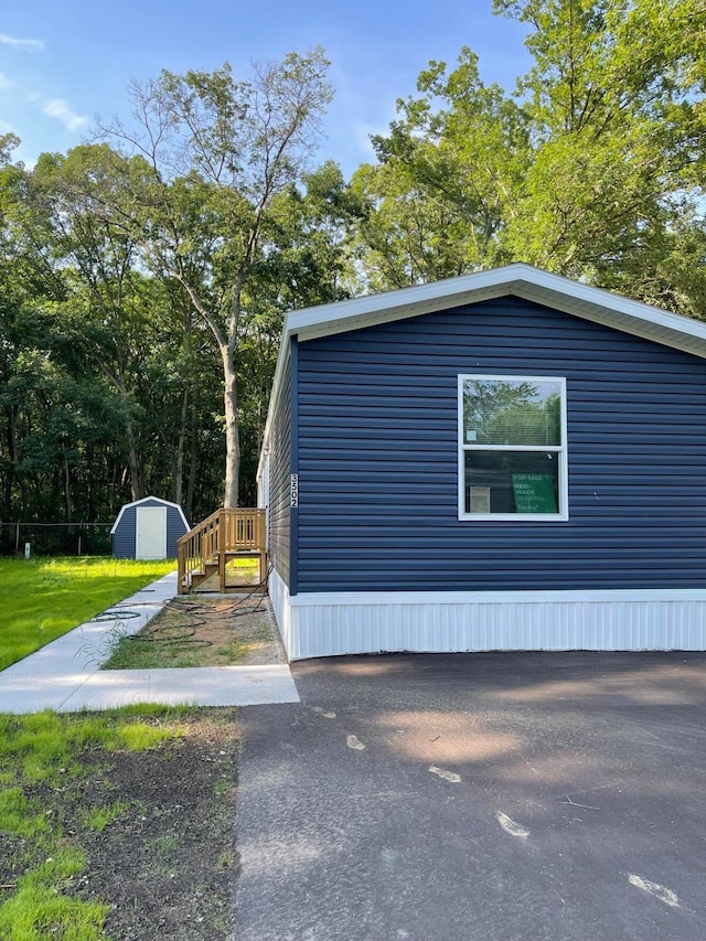 view of home's exterior featuring a storage unit