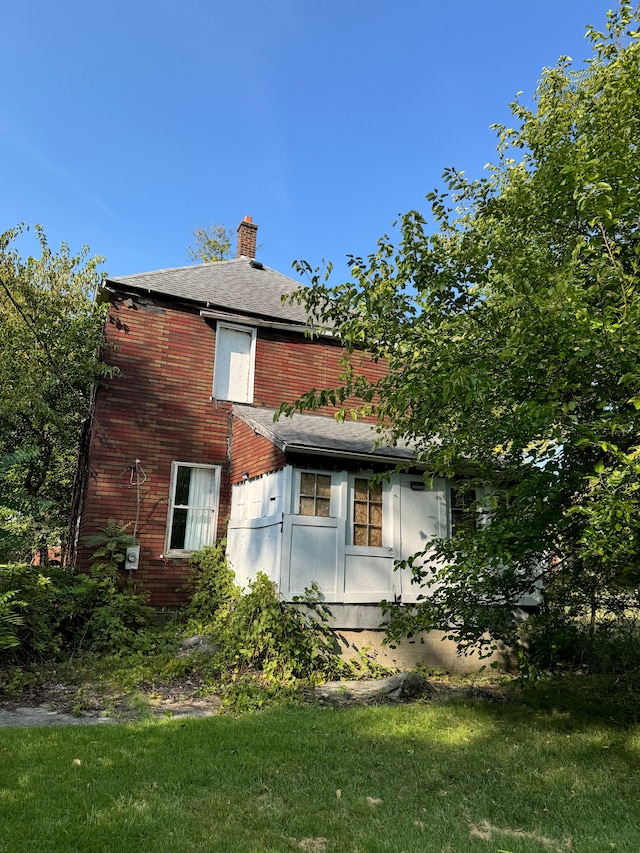 view of home's exterior with a lawn