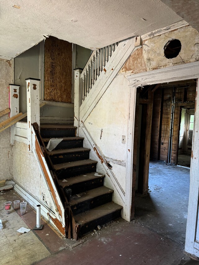 2986 Cadillac Blvd, Detroit, MI 48214 - stairs featuring a textured ceiling