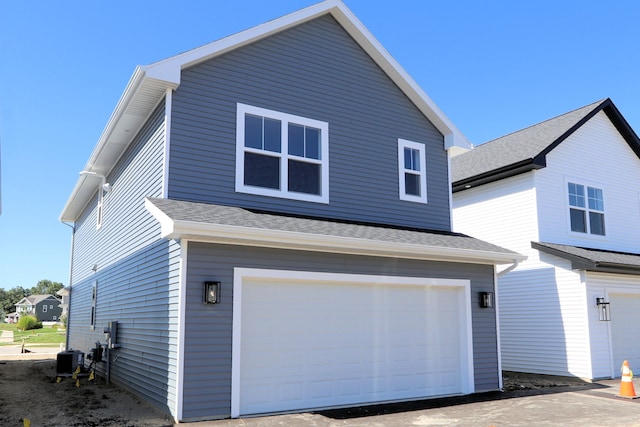 exterior space with a garage and central air condition unit