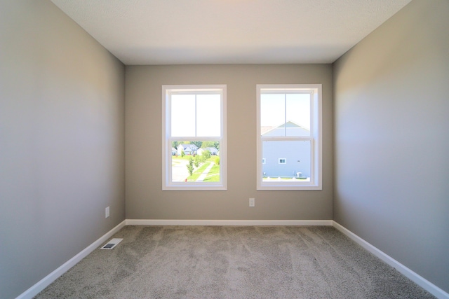 unfurnished room with light colored carpet