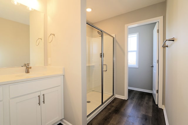 bathroom featuring vanity, a shower with shower door, and hardwood / wood-style floors