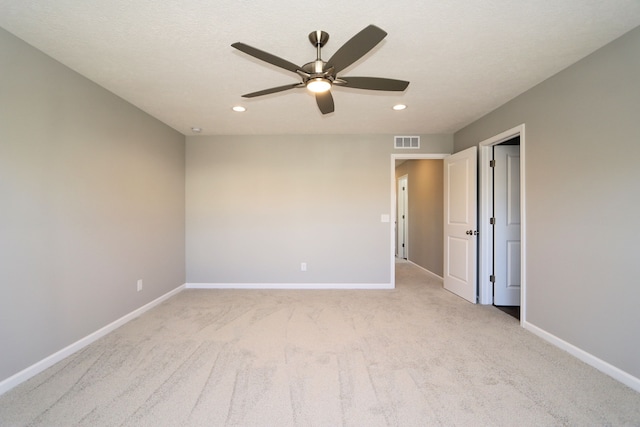 carpeted spare room featuring a textured ceiling and ceiling fan