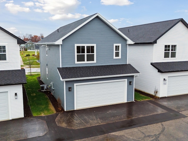 exterior space featuring a garage and central AC unit