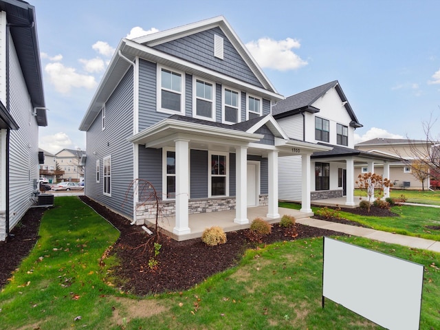 view of front facade with a porch and a front lawn