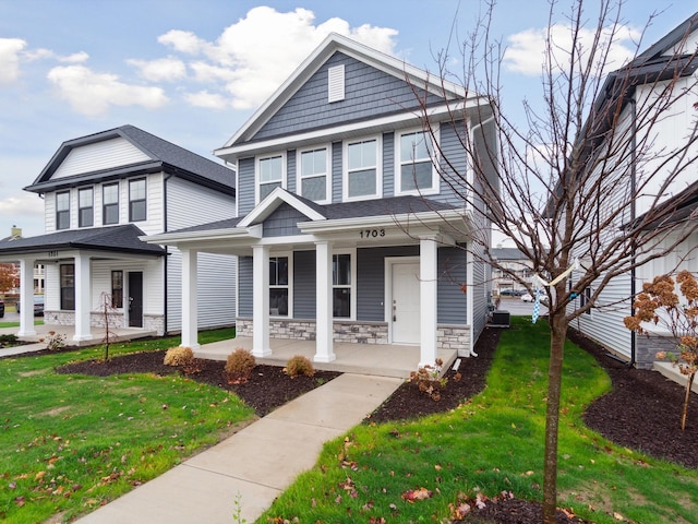 view of front of home featuring covered porch and a front lawn