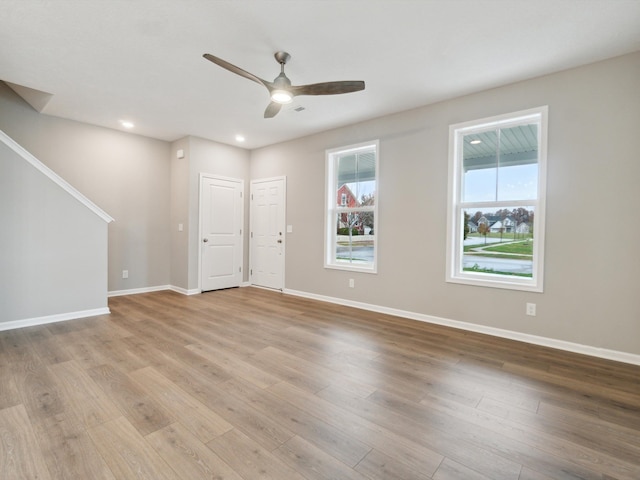 empty room with light hardwood / wood-style flooring and ceiling fan