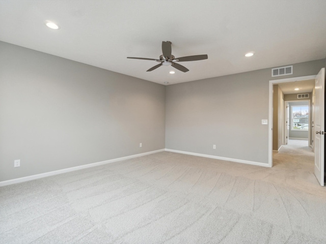 carpeted spare room with ceiling fan