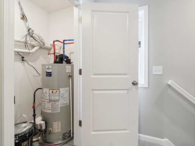 utility room featuring gas water heater