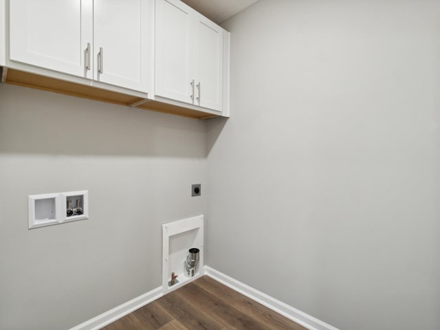 washroom featuring dark wood-type flooring, cabinets, washer hookup, and electric dryer hookup