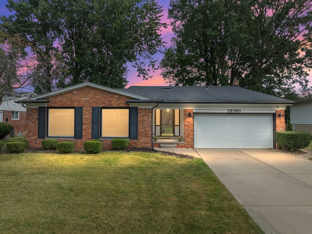 single story home with a yard and a garage