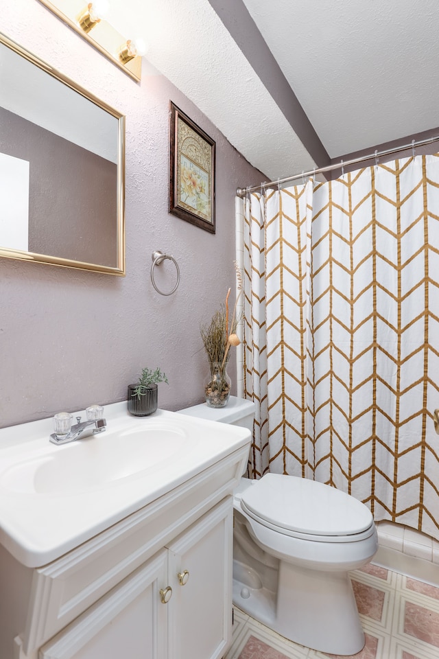 bathroom featuring vanity, a shower with shower curtain, and toilet