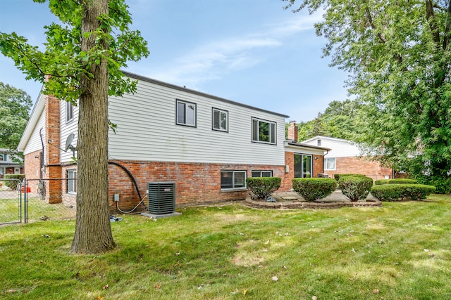 view of front of house featuring a front yard and central AC unit