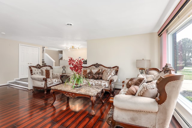 living room with hardwood / wood-style floors and a baseboard heating unit