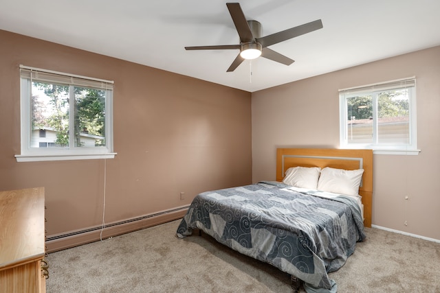 bedroom with baseboard heating, ceiling fan, and light colored carpet