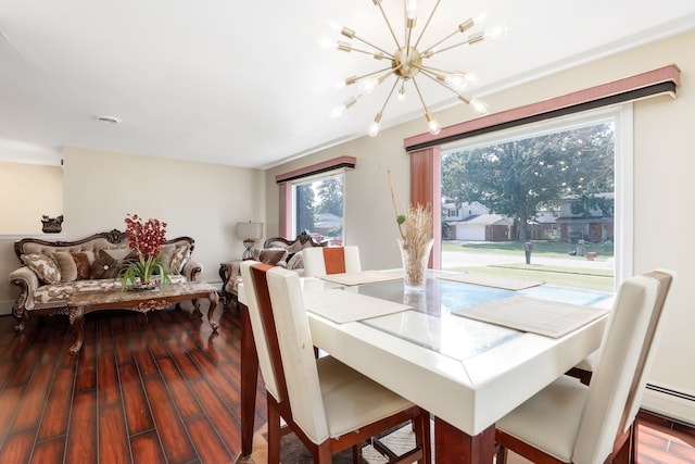 dining area with hardwood / wood-style flooring and an inviting chandelier