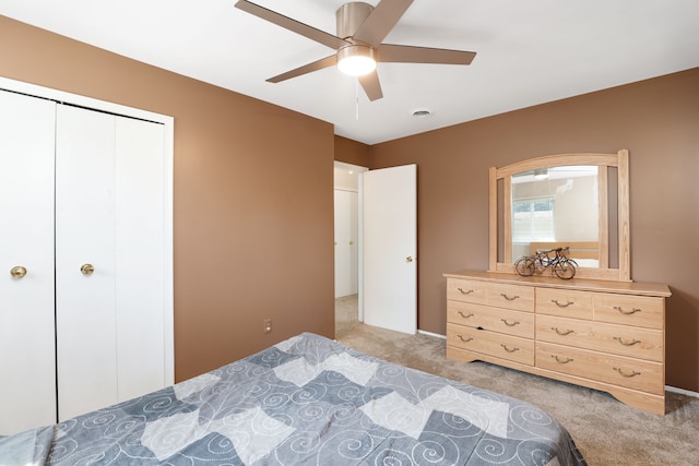 carpeted bedroom with a closet and ceiling fan