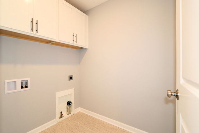 laundry area featuring washer hookup, cabinets, hookup for an electric dryer, gas dryer hookup, and light wood-type flooring