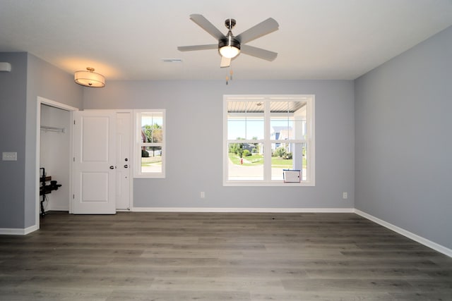 foyer with ceiling fan and dark wood-type flooring