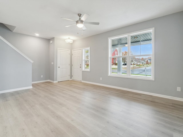 unfurnished living room with ceiling fan and light hardwood / wood-style floors